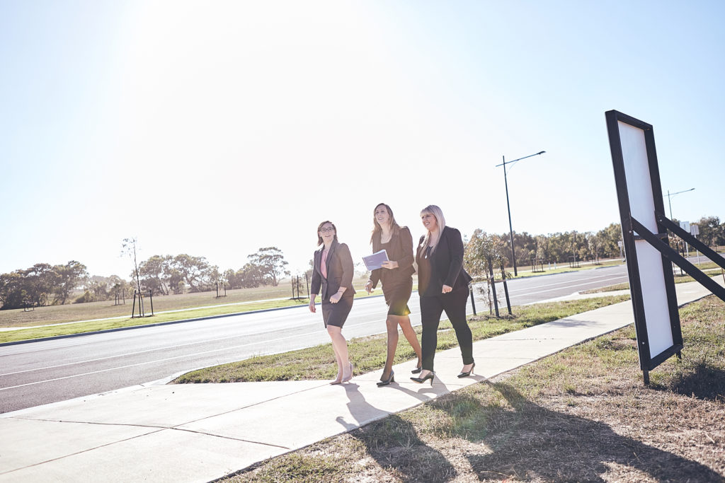 Allison Murphy, Selina Clark and Nicole Hoyle walking along pavement