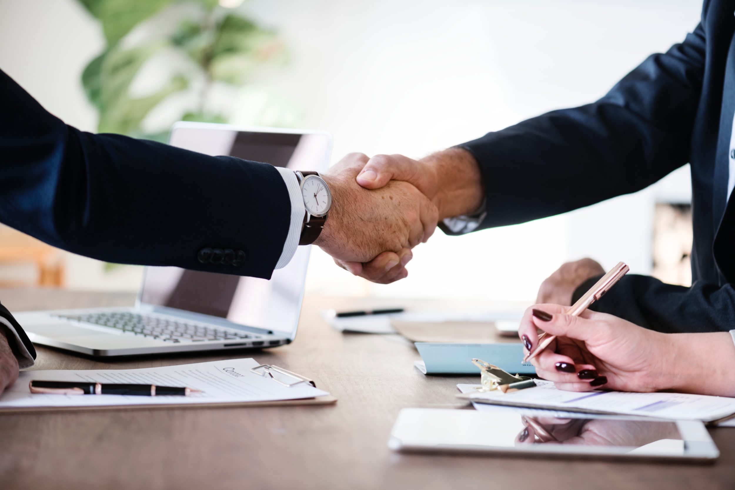 Business handshake in office environment