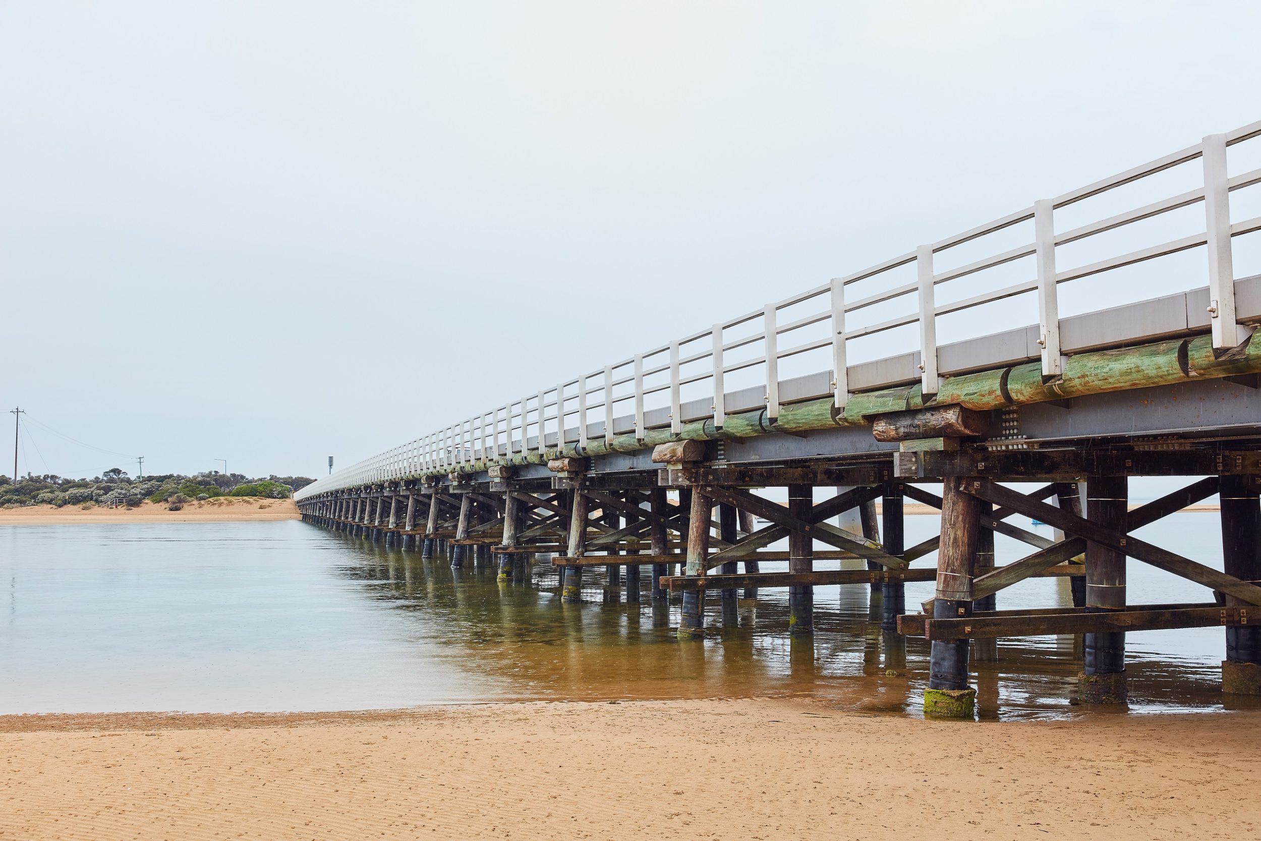 Wooden bridge along beach and water side